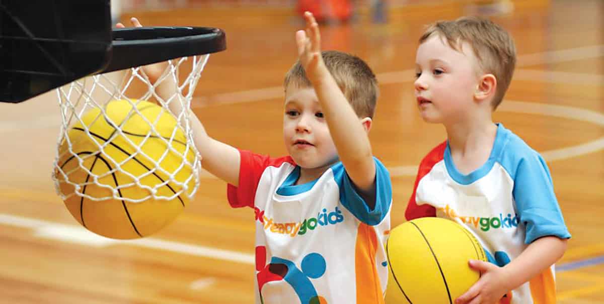 kids playing basketball in a multi-sport program