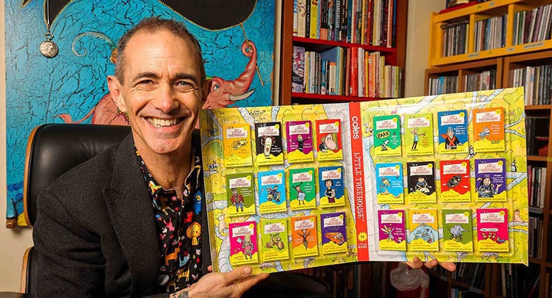 author Terry Denton holding new Coles collectables - a set of Treehouse books