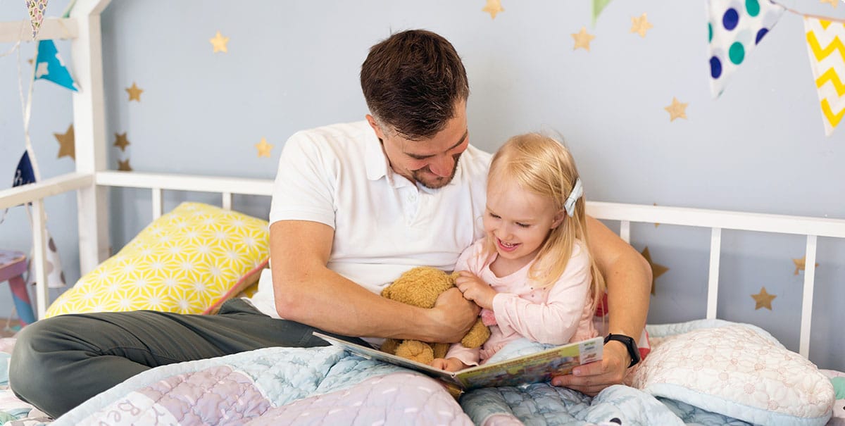 dad reading book to child
