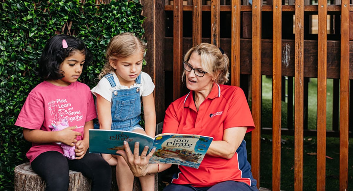 children reading book at Caloundra early learning centre