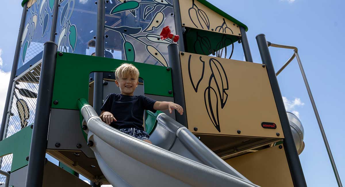 a Boy Plays on a Slide at the New Baringa Forest Park
