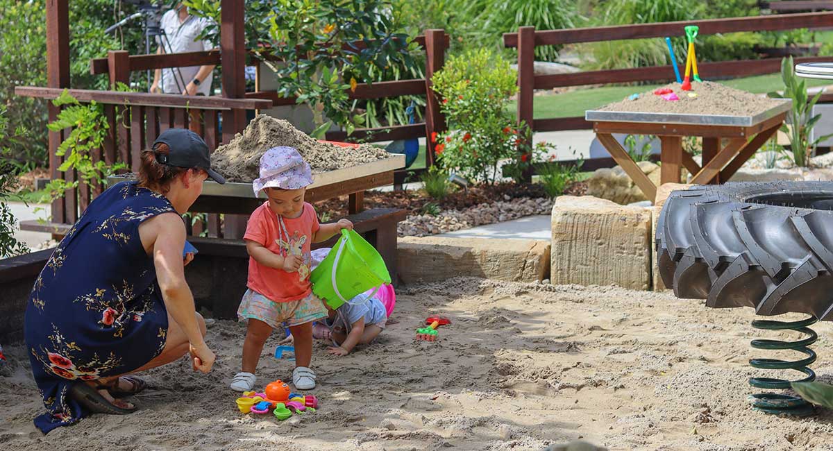 Playing in the Sand at Sunshine Butterflies Accessible Playground