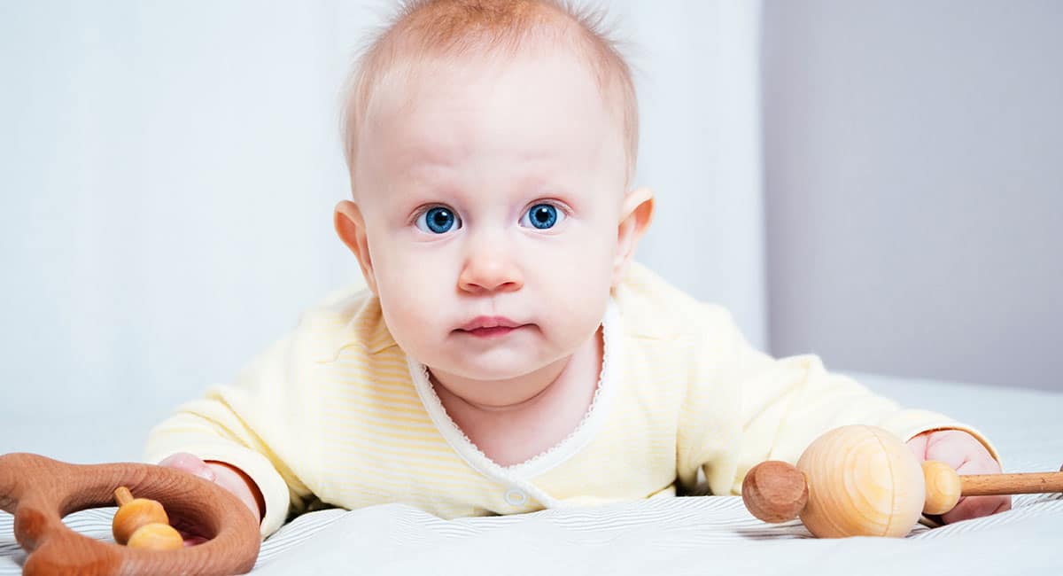 Baby playing with wooden toys