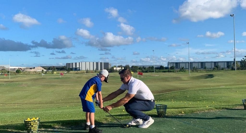 child and coach at Golf Junior Clinics 