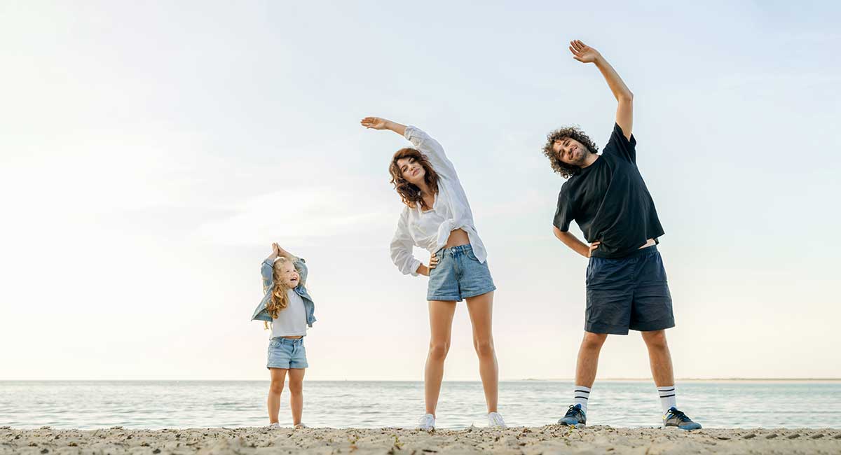 Family Exercising on Beach