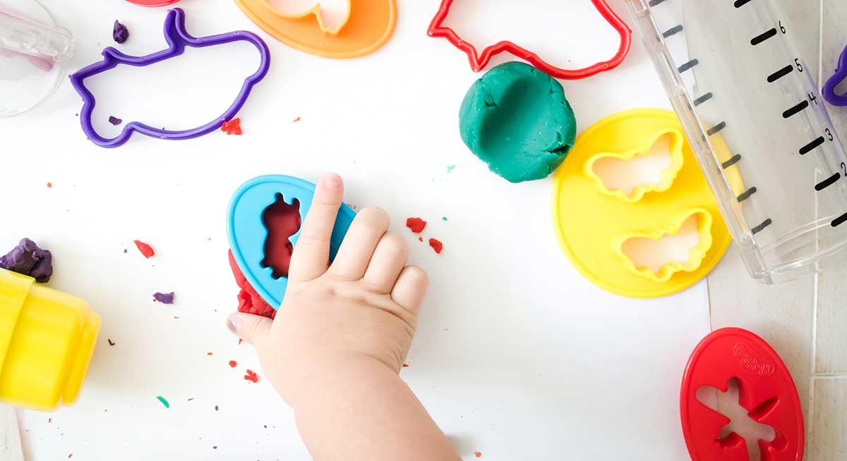 child using playdough in occupational therapy