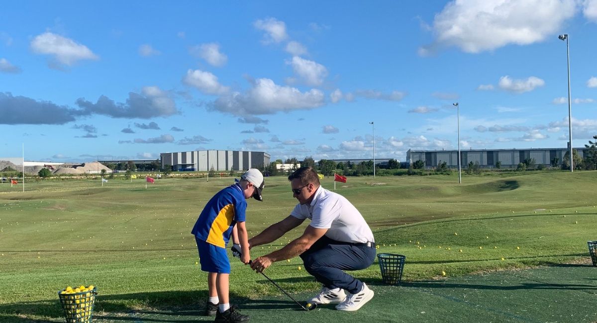 Child at school holiday golf clinic, at Golf Central BNE, Brisbane