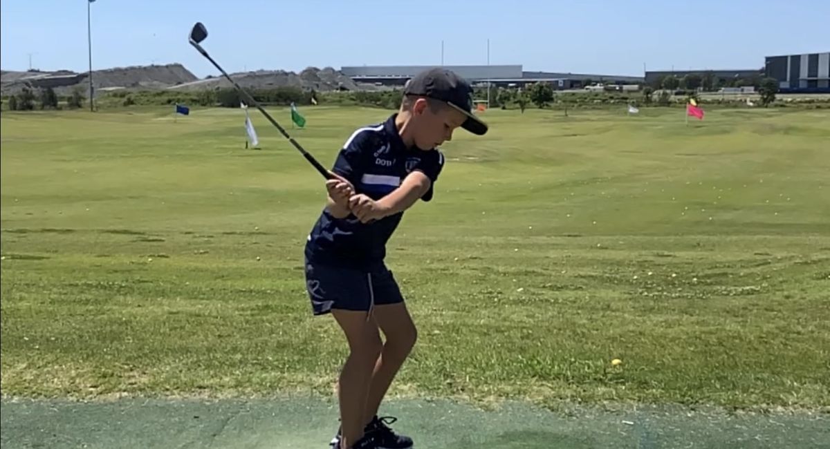 Boy Learning to Play Golf at Bne's Junior Golf Clinic