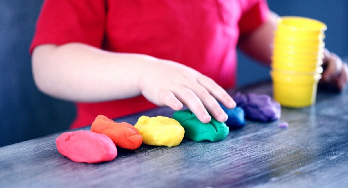 Child Playing with Coloured Play doh