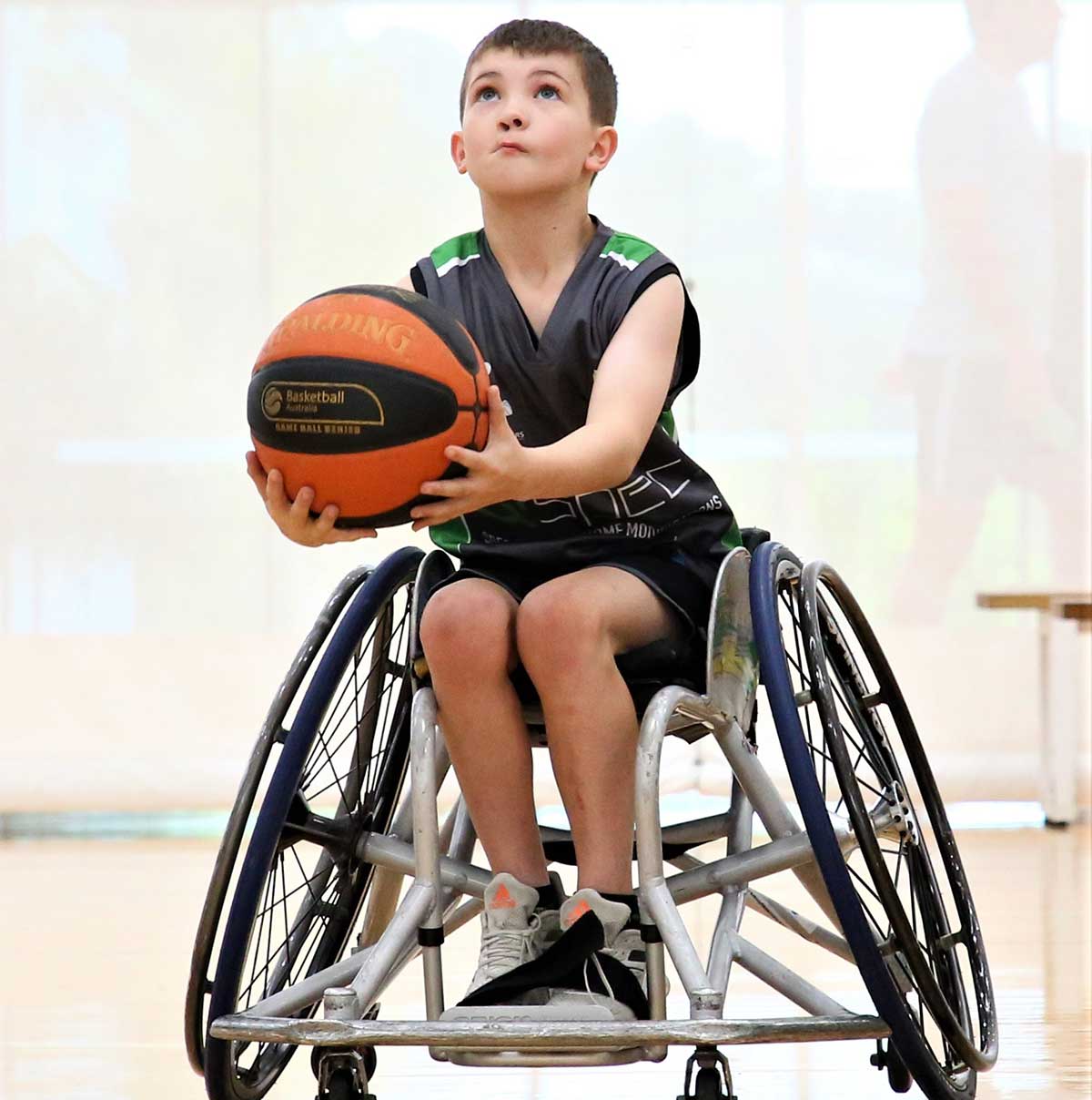 Boy in Wheelchair Throwing Basketball