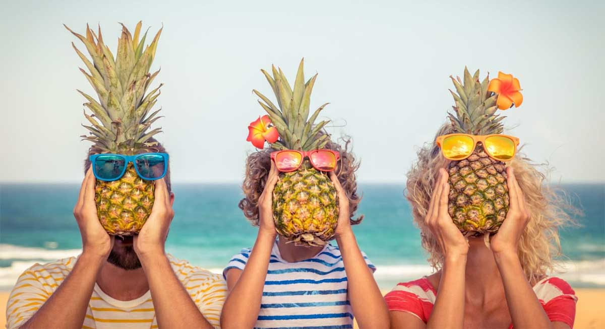 Family Holding Pineapples in Front of Their Faces