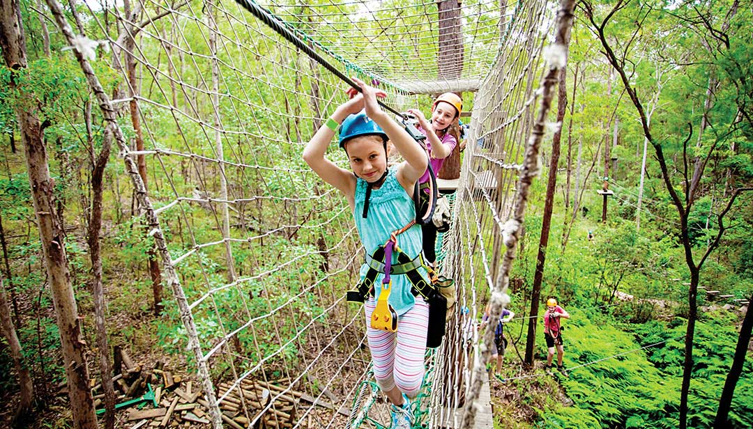 Kids climbing Treetop Challenge ropes course at Thunderbird Park