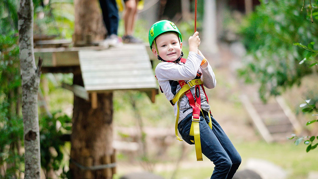 Boy on zipline at Treetop Challenge, Gold Coast