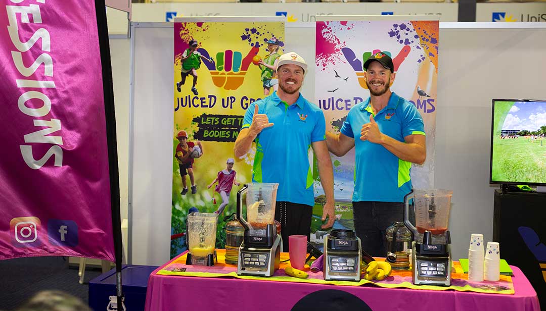 the Juiced Up Groms Stand at the Education Fair 2023