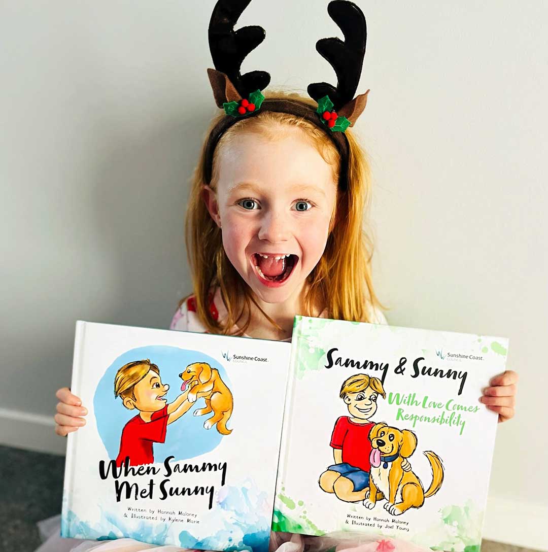 Girl Holding Sunshine Coast Council's Sammy & Sunny books