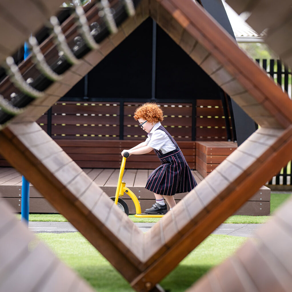 Thelakescollegestudentridingbike | Kids in Brisbane Gold Coast Sunshine Coast | Kotc Child at the Lakes College Riding Bike