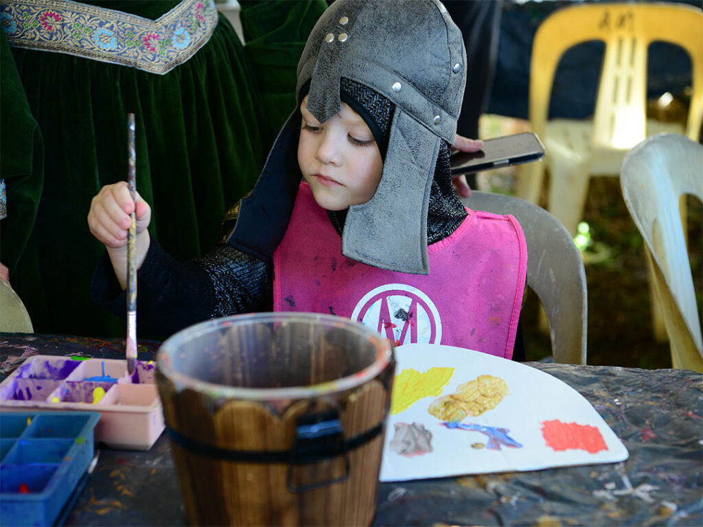 Child Dressed Up in Medieval Clothes Painting at Abbey Medieval Museum