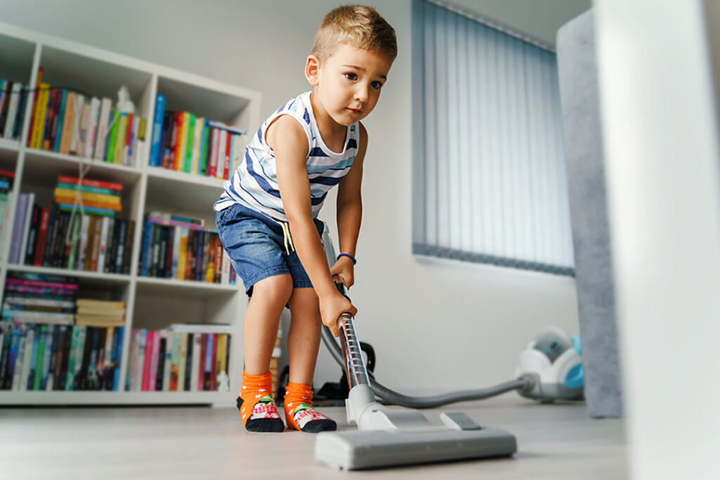 Little Boy Vacuuming the Floor