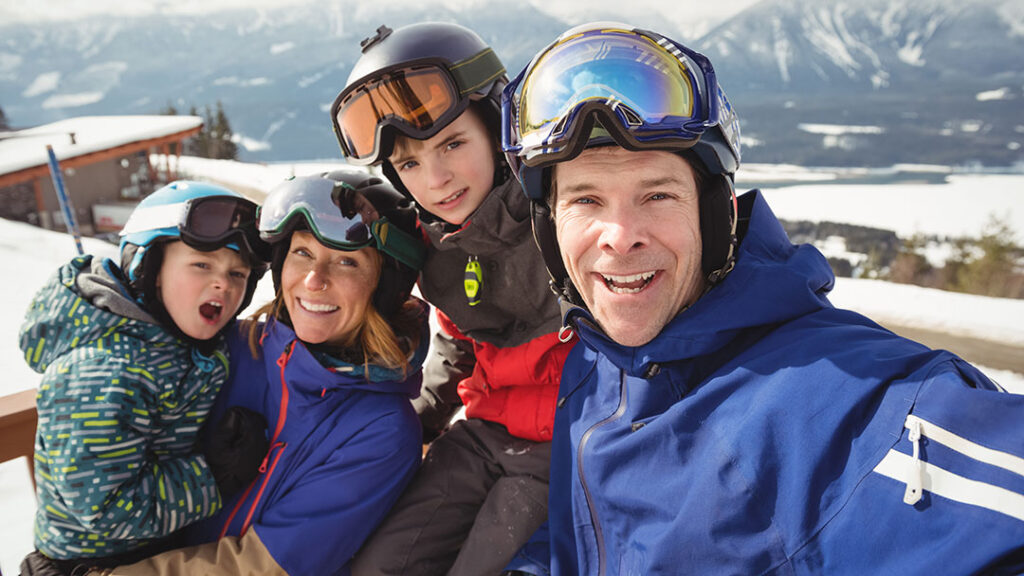Happy Family on a Skiing Holiday Taking Selfie