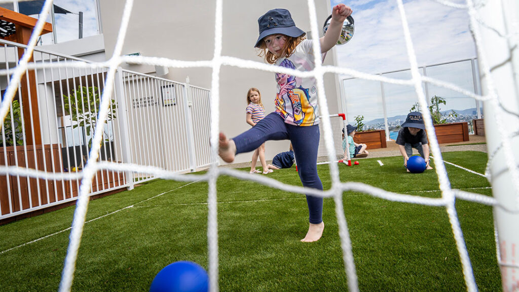 Child Kicking a Ball at New Camp Hill Early Learning Centre Plais Early Learning.