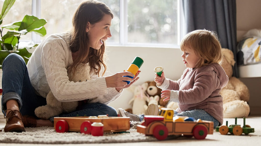 Woman and Child in Play Therapy Session Playing with Toys