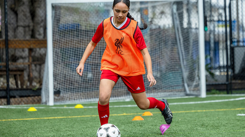Girl Playing Football at the Liverpool Football Club International Academy