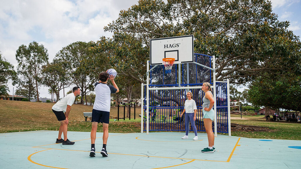 Family Playing Basketball Together Using Free Sports Gear Provided by New Solar-powered Smart Lockers