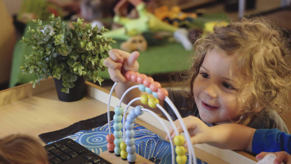 Child Playing with Bead Run at Sanctuary Early Learning Maudsland