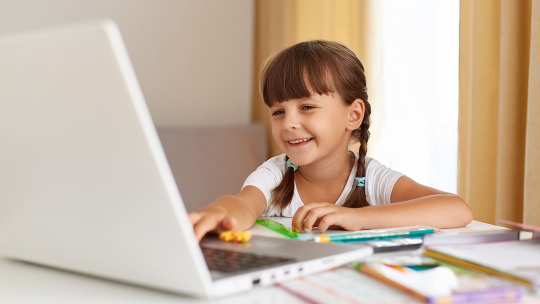 Happy-child-laptop-homework | Kids in Brisbane, Gold Coast, Sunshine Coast | Kotc Happy Child Doing Homework on a Laptop