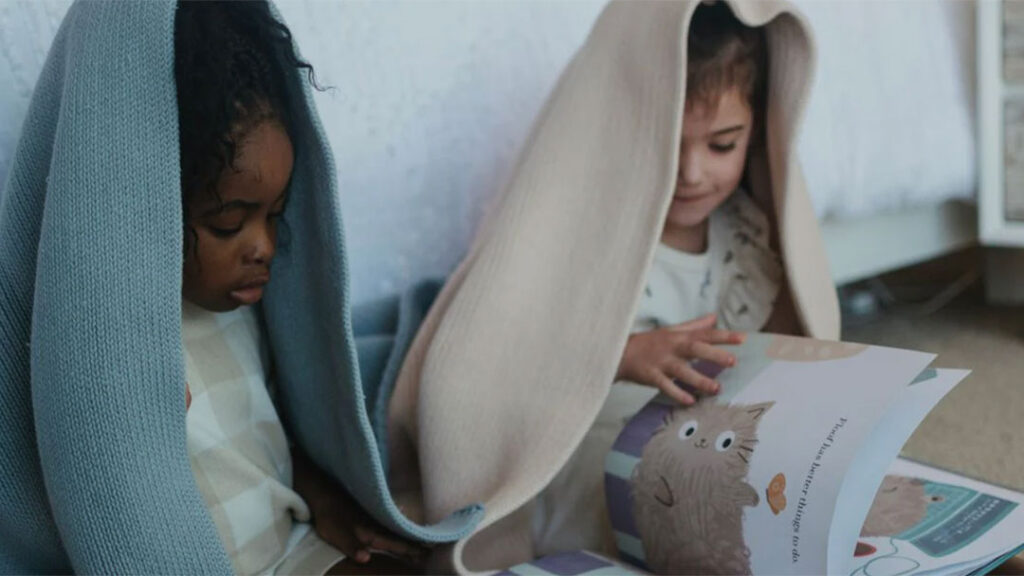 Kids Reading Books Under a Woven Woven Weighted Blanket