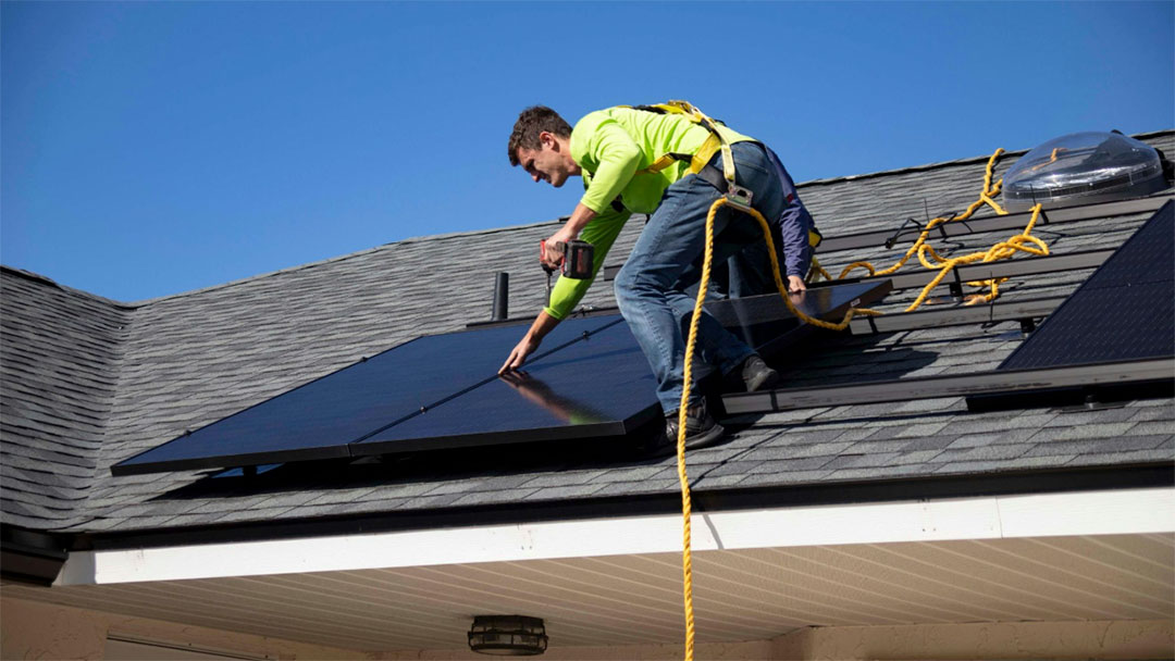 Solar-panels-installer | Kids in Brisbane, Gold Coast, Sunshine Coast | Kotc Person Installing Solar Panels on a Roof