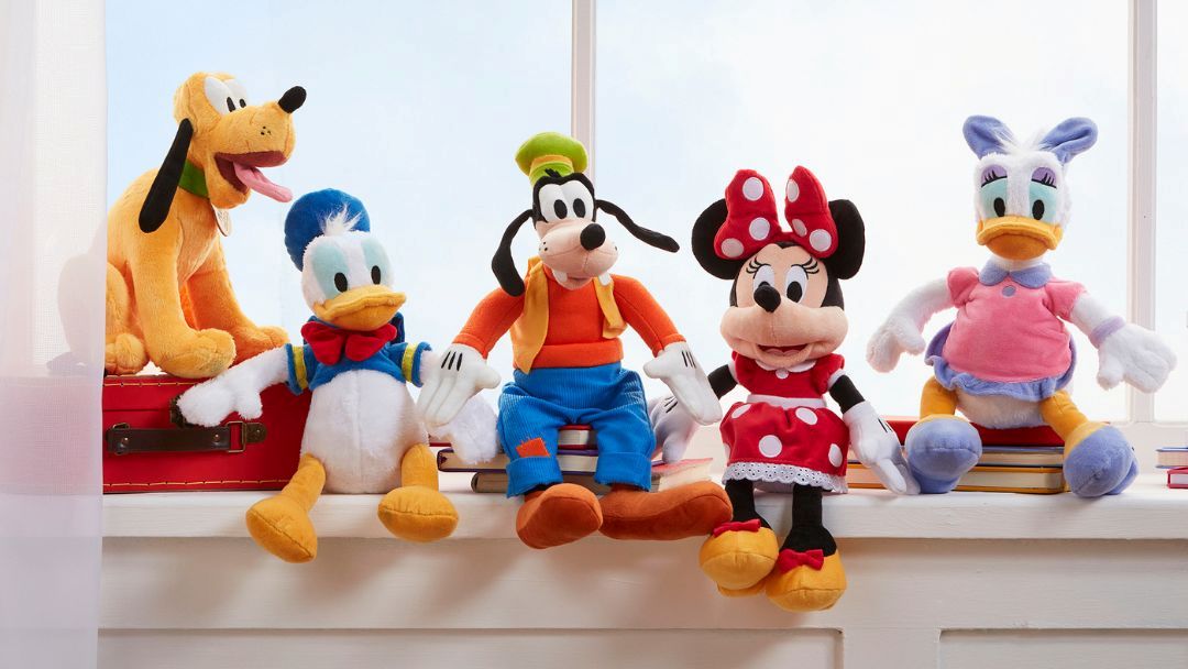 Colorful Stuffed Toy Characters—pluto, Donald Duck, Goofy, Minnie Mouse, and Daisy Duck—sitting on a Bright Windowsill Across a Sunny Background.
