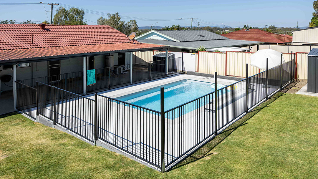 a House in Logan with a Backyard Pool Securely Protected by a Pool Fence