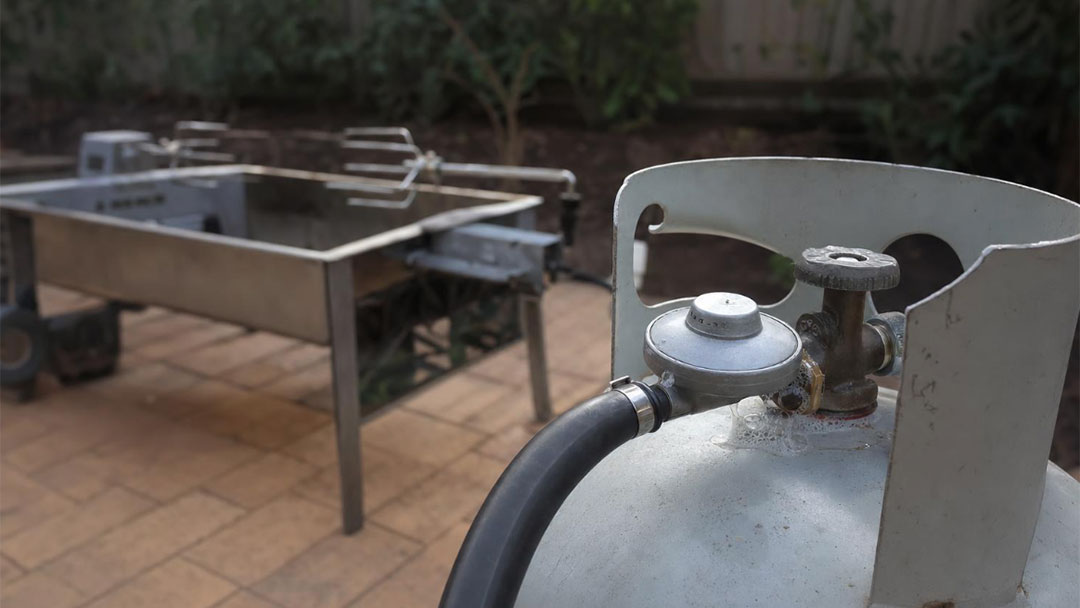 Spit Rotisserie with Gas Bottle in a Backyard in Australia