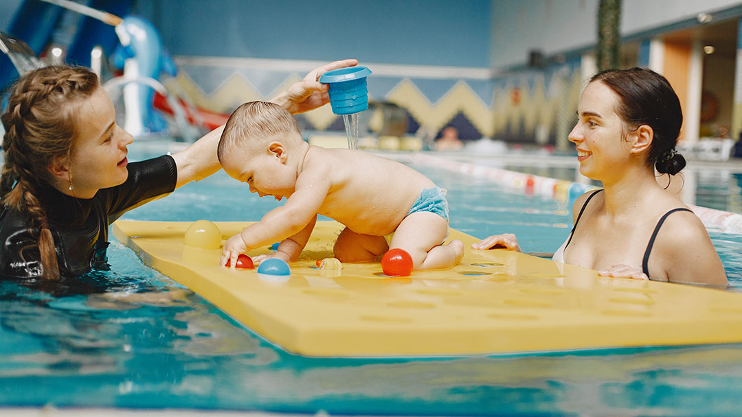 Mother, Baby and Swim Teacher at Baby Splash and Play Session