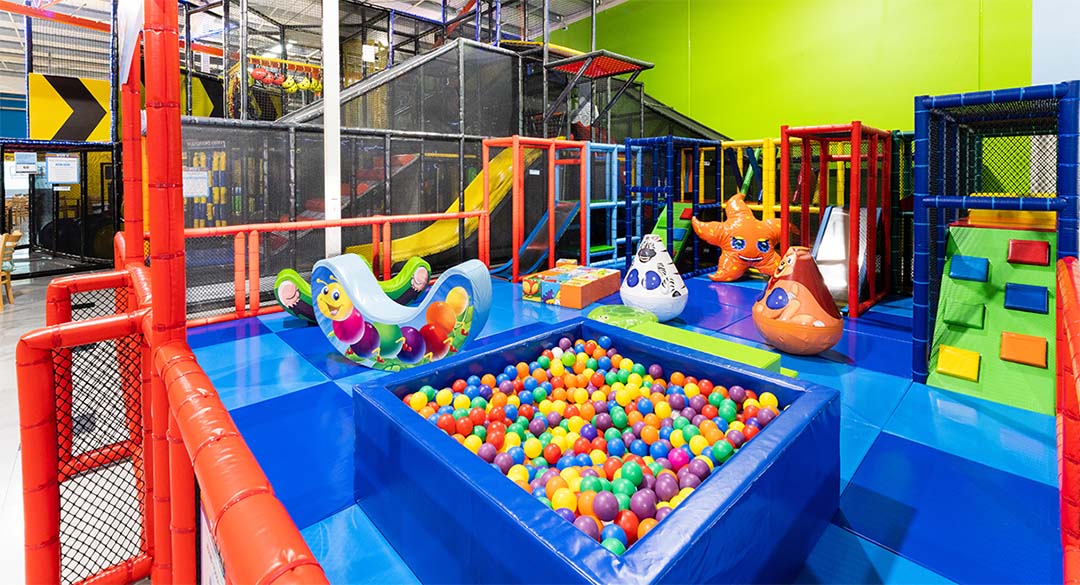 Rush Adventureland Toddler | Kids in Brisbane, Gold Coast, Sunshine Coast | Kotc Colorful Indoor Kids' play area with a ball pit, slides, and soft climbing structures for children.