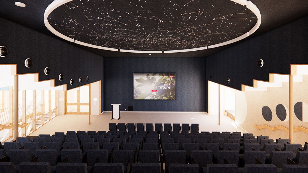 The-canticle---lecture-theatre | Kids in Brisbane, Gold Coast, Sunshine Coast | Kotc Auditorium with Dark Walls, Tiered Navy Seats, and a Large Screen at the Front Behind a Podium; Circular Ceiling Mural of Constellations.