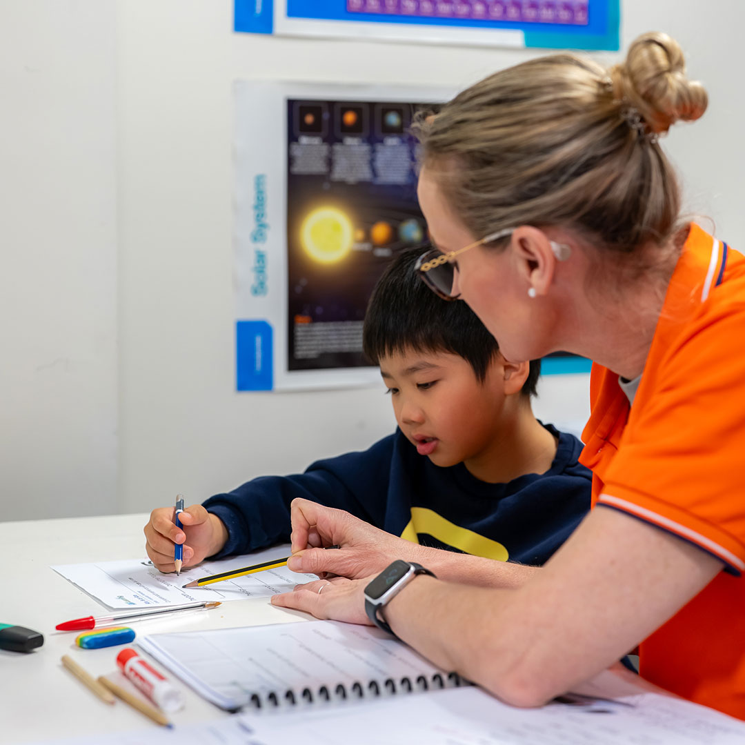 Tutor at Twinkle Academy Gold Coast Tutoring Assists a Student with Study.
