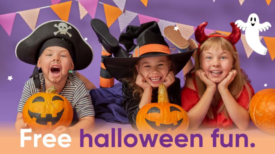 1013_brooksideshoppingcentre_halloween_hero | Kids in Brisbane, Gold Coast, Sunshine Coast | Kotc Three Smiling Children in Halloween Costumes (pirate, Witch, and Devil) Pose with Carved Pumpkins Against a Purple Backdrop with Bunting.
