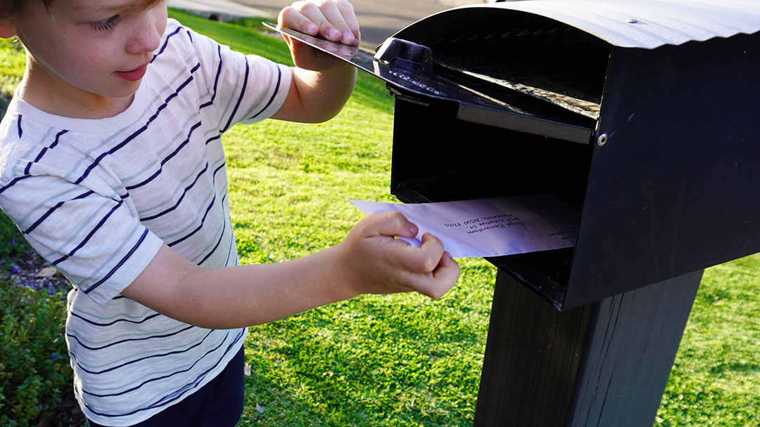 Child Taking Ocean Explorer Mail from Letterbox
