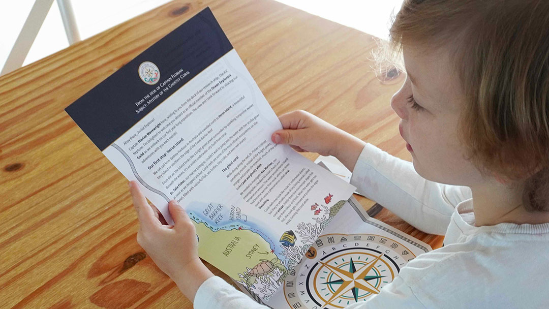 Ocean-explorers-mail-reading-letter | Kids in Brisbane, Gold Coast, Sunshine Coast | Kotc Child Reading Ocean Explorer Mail